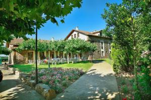 a house with a garden in front of it at Valle Del Eria Hotel in Castrocontrigo