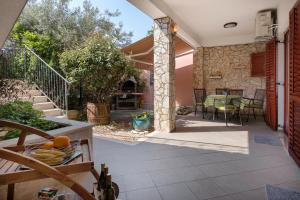 a patio with a table and chairs on a house at Meri in Premantura