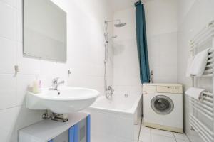 a bathroom with a sink and a washing machine at Tulpen Residenz in Offenbach