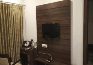 a bathroom with a wooden wall with a television on it at MPT Tourist Motel, Dodi in Dodi