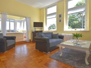 a living room with a couch and a table at ground floor apartment in Blankenburg in Blankenburg