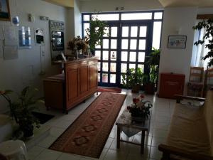 a living room with a large door and a rug at Angelos Hotel in Agios Nikolaos