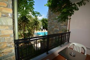 a balcony with a view of a pool at Villa Eden in Limenas