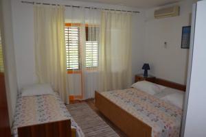 Postel nebo postele na pokoji v ubytování Apartman Linda