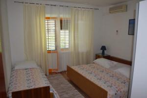 Postel nebo postele na pokoji v ubytování Apartman Linda