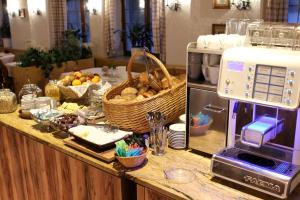 a kitchen counter with a toaster and a basket of food at Hotel Keindl in Oberaudorf