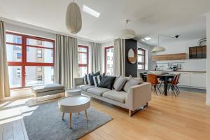 a living room with a couch and a table at Blue Mandarin Island in Gdańsk