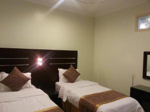 Cama o camas de una habitación en Elaf Suits