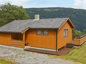 a small house with a porch and a roof at Three-Bedroom Holiday home in Utvik 1 in Reed