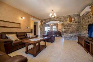 a living room with a couch and a tv at Villa Old Castle Apartments in Kotor