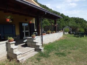 a house with a stone wall and a patio at Casetta dei "Prati" in Vaglio di Basilicata