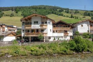 a large white building on the side of a mountain at alpenrose hotel-garni in Gerlos