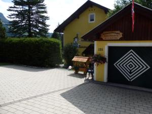 a building with a garage with a sign on it at Apartments Haus Steinbock in Tauplitz