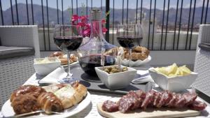a table topped with glasses of wine and food at THE VIEW in Palermo