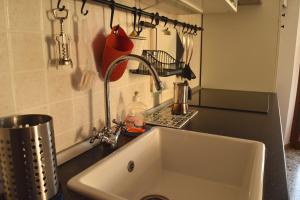 a kitchen counter with a sink in a kitchen at Veronauptoyou Apartments in Verona +37 photos