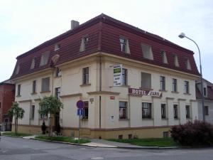 a large building with a brown roof on a street at Hotel Jaro in Mělník