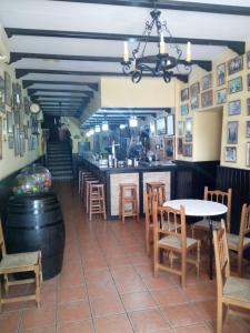 a restaurant with a table and chairs and a bar at La Posada de Eustaquio in Canjáyar +15 photos