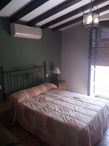 a bedroom with a bed and a window at La Posada de Eustaquio in Canjáyar