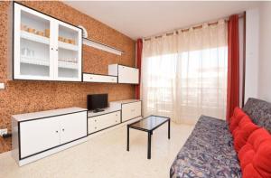 a living room with a couch and a tv at Apartamento Pineda in Pineda de Mar