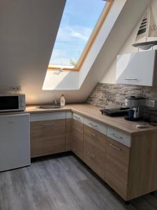 a kitchen with a large skylight in the ceiling at Marci Apartman in Balatonboglár