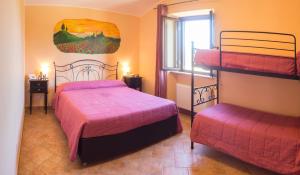 a bedroom with two bunk beds and a window at Agriturismo Ferrari in Caprarola