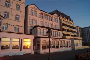 a building with a street light in front of it at Strandhotel Ostfriesenhof in Borkum