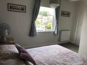 a bedroom with a bed and a window at Holden House in Shardlow