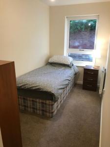 a small bedroom with a bed and a window at Southampton Gem in Southampton