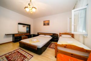 a bedroom with two beds and a mirror at Apartments Bozena in Krk