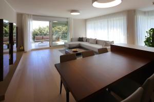a living room with a table and a couch at Stylish apartment 100 m from the beach in Opatija