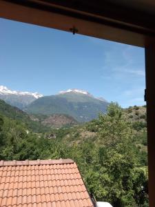 a view of a mountain from a window at Casa per vacanze in Meana di Susa in Meana di Susa
