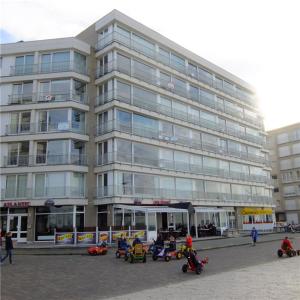 a large building with motorcycles parked in front of it at Atlantic 0504 in Koksijde