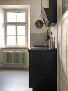 a kitchen with a black counter and a window at Luna Estela in Bayreuth +10 photos