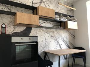 a kitchen with a table and a black oven at Luna Estela in Bayreuth