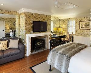 a living room with a bed and a fireplace at The Crown Inn in Peterborough