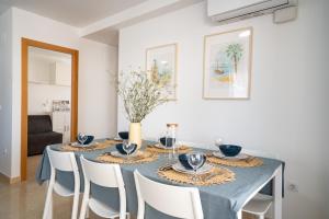 a dining room with a blue table and chairs at Ideally Located Holiday Apartment in Moncófar