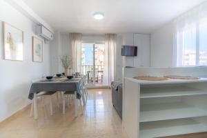 a kitchen and dining room with a table and chairs at Ideally Located Holiday Apartment in Moncófar