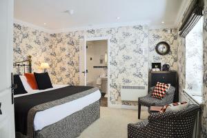 a hotel room with a bed and a bathroom at The Crown Inn in Peterborough
