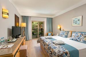 a hotel room with two beds and a television at Xanadu Resort Hotel - High Class All Inclusive in Belek