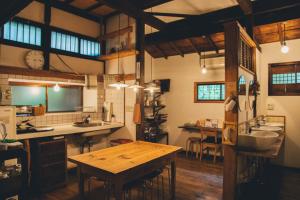 una gran cocina con una mesa de madera. en Guesthouse toco en Tokio