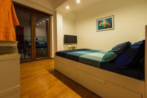 a bedroom with a large bed and a television at L'Approdo B&B in Gaeta