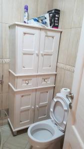 a bathroom with a white cabinet and a toilet at Apartman Jasovic in Risan