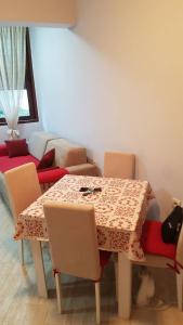 a dining room with a table and chairs and a couch at Apartman Jasovic in Risan