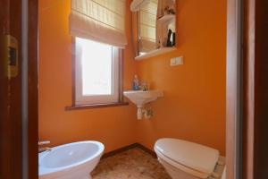 a bathroom with a white toilet and a sink at Rannakorterid Pärnu rannas in Pärnu