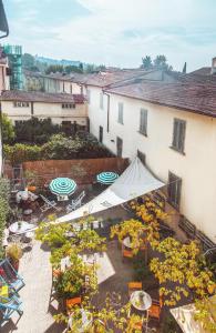 una vista aérea de un patio con mesas y sombrillas en Ostello Tasso en Florencia