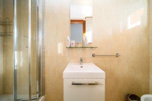 a bathroom with a sink and a shower at Apartments Bozena in Krk