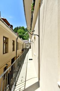 an alley between two buildings with a balcony at Safrano Palace in Braşov