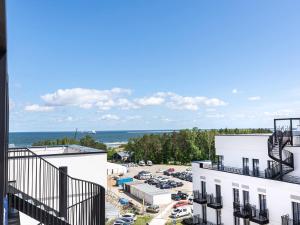 a view from the balcony of a building with a parking lot at VacationClub – Baltic Park Fort Apartament E.506 in Świnoujście