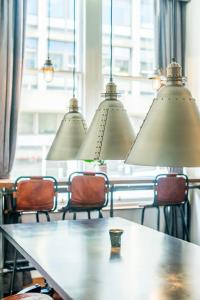 a dining room table with chairs and a lamp at The Z Hotel Glasgow in Glasgow