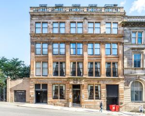 an old brick building on the corner of a street at The Z Hotel Glasgow in Glasgow